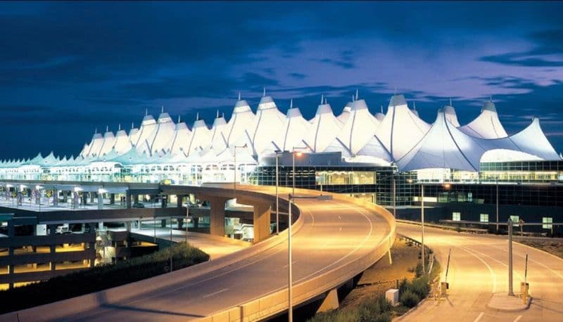 Denver International Airport’s terminal and roadway at dusk.
