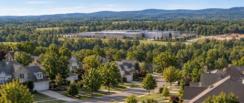 An aerial view of a data center campus beyond a residential neighborhood.